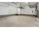 Spacious garage with concrete flooring and overhead storage racks at 565 Joseph Alexander Dr, Fuquay Varina, NC 27526