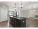 Stylish kitchen island with granite countertop, sink, and an open view into the living area at 565 Joseph Alexander Dr, Fuquay Varina, NC 27526