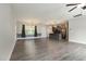 Spacious living area featuring modern gray flooring, large windows, and an open layout at 565 Joseph Alexander Dr, Fuquay Varina, NC 27526