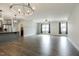 Open-concept living area with stylish lighting, hardwood floors, and neutral wall paint at 565 Joseph Alexander Dr, Fuquay Varina, NC 27526