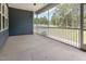 Covered screened-in porch with concrete flooring and views of the backyard at 565 Joseph Alexander Dr, Fuquay Varina, NC 27526