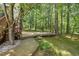 Lush backyard featuring a multi-tiered wooden deck shaded by mature trees at 5704 Cholderton Ct, Raleigh, NC 27604