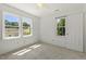 Bright bedroom with natural light from two windows and neutral carpeting at 5704 Cholderton Ct, Raleigh, NC 27604