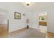 Neutral dining room with hardwood floors, wainscoting, and a glimpse of the connecting kitchen at 5704 Cholderton Ct, Raleigh, NC 27604
