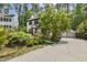 Well-maintained home with a long driveway leading to a detached garage and lush landscaping at 5704 Cholderton Ct, Raleigh, NC 27604