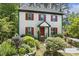 Charming two-story home with red shutters, landscaped yard, and forest backdrop at 5704 Cholderton Ct, Raleigh, NC 27604