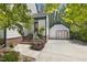 Side angle of a two-story home with red brick steps and a detached garage at 5704 Cholderton Ct, Raleigh, NC 27604