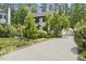 Two-story home with a long driveway leading to a detached garage and lush landscaping at 5704 Cholderton Ct, Raleigh, NC 27604