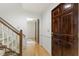 Welcoming foyer with hardwood floors, a staircase with white spindles, and a dark wooden door at 5704 Cholderton Ct, Raleigh, NC 27604