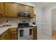 Updated kitchen with stainless steel appliances, tile backsplash, and beautiful wooden cabinetry at 5704 Cholderton Ct, Raleigh, NC 27604
