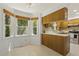 Kitchen with natural wood cabinetry and stainless-steel appliances with a breakfast nook and backyard view at 5704 Cholderton Ct, Raleigh, NC 27604