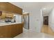 Bright kitchen with tile floor, white countertops, and stainless-steel appliances with wood cabinets at 5704 Cholderton Ct, Raleigh, NC 27604