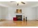 Bright living room with hardwood floors, a fireplace, and a ceiling fan at 5704 Cholderton Ct, Raleigh, NC 27604