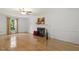Well-lit living room featuring hardwood floors, fireplace, a ceiling fan and a large window at 5704 Cholderton Ct, Raleigh, NC 27604