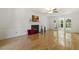 Bright living room with hardwood floors, a fireplace, and French doors leading to sunroom at 5704 Cholderton Ct, Raleigh, NC 27604