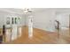 Bright living room with hardwood floors, ceiling fan, and natural light from the doors leading to sunroom at 5704 Cholderton Ct, Raleigh, NC 27604