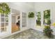 Charming sunroom featuring tile floors, large windows with natural light, and access to a cozy living space at 5704 Cholderton Ct, Raleigh, NC 27604