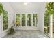 Bright sunroom with tile flooring and large windows offering scenic views of the surrounding landscape at 5704 Cholderton Ct, Raleigh, NC 27604