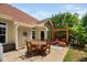 Charming back patio features a dining table with chairs and a cozy seating area with a pergola at 60 Morning Mist Dr, Garner, NC 27529