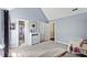 Bright bedroom with ensuite bath featuring a dresser with a mirror, neutral carpet, and access to other rooms at 60 Morning Mist Dr, Garner, NC 27529