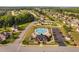 Aerial shot of a community pool area, featuring a clubhouse, swimming pool, parking lot, and manicured landscaping at 60 Morning Mist Dr, Garner, NC 27529