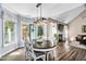 Bright dining area with a wood table set, adjacent to the living room and overlooking the backyard at 60 Morning Mist Dr, Garner, NC 27529