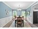 Elegant dining room boasting soft blue walls, crown molding, and a table set for a delightful meal at 60 Morning Mist Dr, Garner, NC 27529