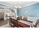 Well-lit dining room featuring blue walls, and seating for six, perfect for Gathering gatherings at 60 Morning Mist Dr, Garner, NC 27529
