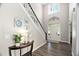 Grand entryway with soaring ceilings, elegant chandelier, staircase, and beautiful dark wood floors at 60 Morning Mist Dr, Garner, NC 27529