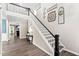 Open entryway showcasing hardwood floors, elegant staircase, and view to the living room at 60 Morning Mist Dr, Garner, NC 27529