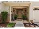 Inviting covered entrance showcasing a stone facade, stylish planters, and a welcoming entryway at 60 Morning Mist Dr, Garner, NC 27529