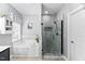 Spacious main bathroom with a separate shower and soaking tub, tiled floors and modern finishes at 60 Morning Mist Dr, Garner, NC 27529