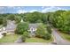 An aerial view of a home with a driveway and professionally landscaped lawn at 600 Driftwood Dr, Gibsonville, NC 27249