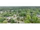 An aerial view of a home surrounded by lush green trees in a quiet neighborhood at 600 Driftwood Dr, Gibsonville, NC 27249
