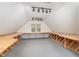 Spacious attic featuring finished floor, storage, built-in work surfaces, bright lighting, and abundant space at 600 Driftwood Dr, Gibsonville, NC 27249