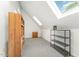 Finished attic space with a skylight, carpeting, built in shelves, and views of the neighborhood at 600 Driftwood Dr, Gibsonville, NC 27249