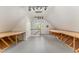 Bright attic with built-in tables, storage, and window. Ideal for hobby enthusiasts or home office setups at 600 Driftwood Dr, Gibsonville, NC 27249