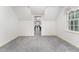 Attic featuring grey carpet, a window with drapes and views into an adjacent room at 600 Driftwood Dr, Gibsonville, NC 27249