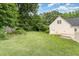 Spacious backyard with a lawn and a wooded area at 600 Driftwood Dr, Gibsonville, NC 27249