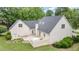 Brick home exterior featuring manicured lawn, patio, and lush landscaping, creating a serene backyard oasis at 600 Driftwood Dr, Gibsonville, NC 27249