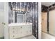 Bathroom featuring floral wallpaper, a large mirror, a vanity, and a glass enclosed shower at 600 Driftwood Dr, Gibsonville, NC 27249
