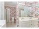 Bathroom featuring floral wallpaper, a double sink vanity, a toilet and a glass enclosed shower at 600 Driftwood Dr, Gibsonville, NC 27249