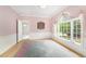 Bright bedroom with hardwood floors, a large window, and connected powder room at 600 Driftwood Dr, Gibsonville, NC 27249
