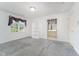 Bedroom featuring grey carpet, a window with drapes, a closet and views of an adjacent bathroom at 600 Driftwood Dr, Gibsonville, NC 27249