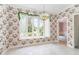Traditional dining room with large window, floral wallpaper, and modern chandelier at 600 Driftwood Dr, Gibsonville, NC 27249