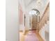 Bright foyer with hardwood floors, staircase, and arched doorway to outside at 600 Driftwood Dr, Gibsonville, NC 27249