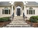 Inviting front porch features columns and an arched doorway at 600 Driftwood Dr, Gibsonville, NC 27249