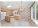 Eat-in kitchen with island and wood cabinets plus view of backyard at 600 Driftwood Dr, Gibsonville, NC 27249