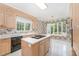 Eat-in kitchen with island and wood cabinets and large window at 600 Driftwood Dr, Gibsonville, NC 27249