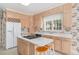 Traditional kitchen with light wood cabinets, central island and white countertops and appliances at 600 Driftwood Dr, Gibsonville, NC 27249